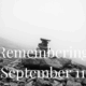 Black and white photo of a rock cairn with text overlay: Remembering September 11.