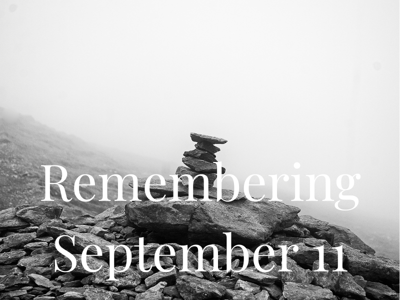 Black and white photo of a rock cairn with text overlay: Remembering September 11.