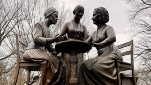 three women in bronze sitting at a table