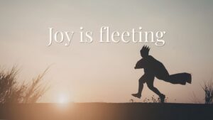 child silhouette running with cape at sunset